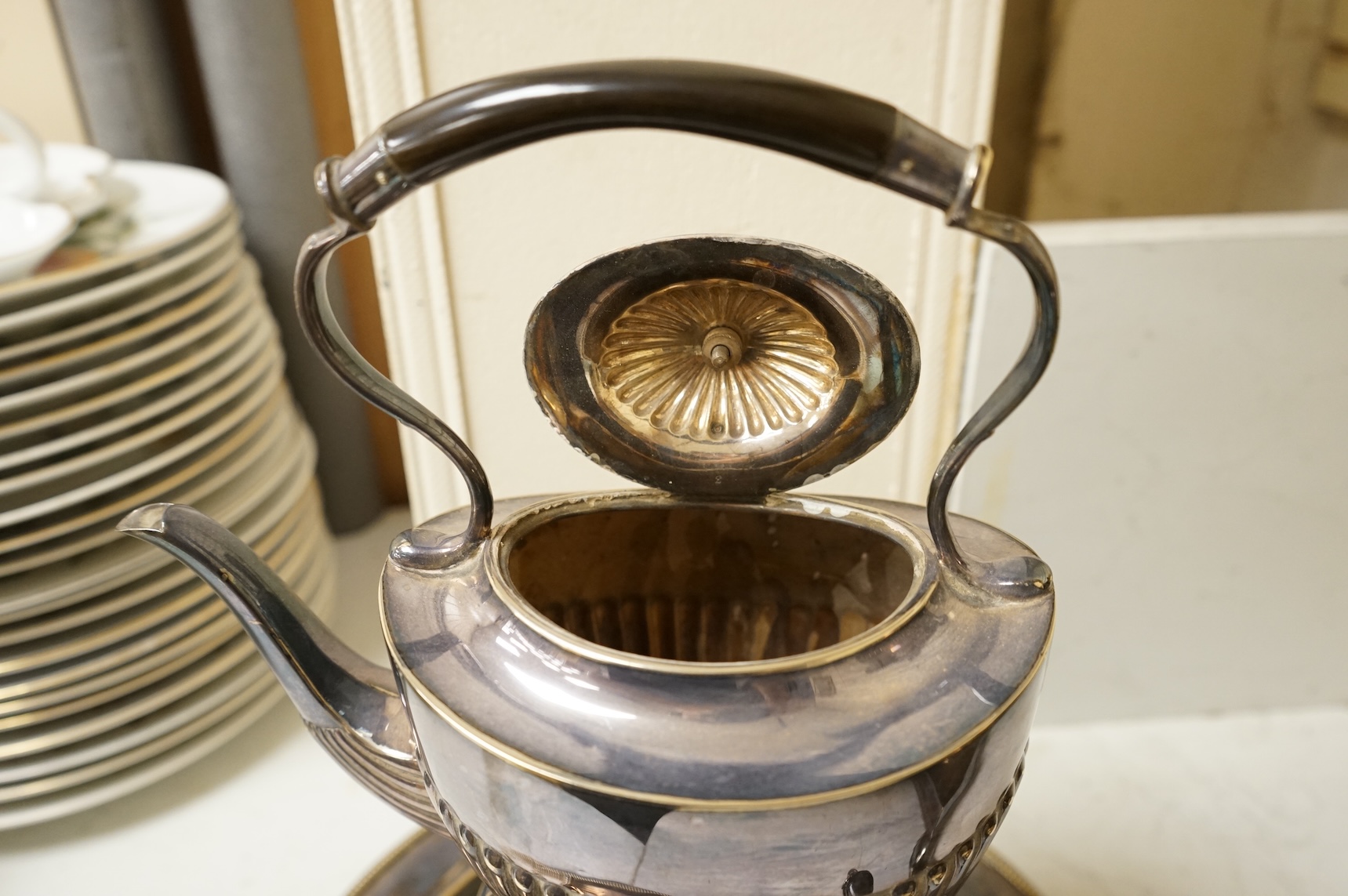 A Victorian silver plated urn, height 42cm, a silver plated spirit kettle and two circular dishes.